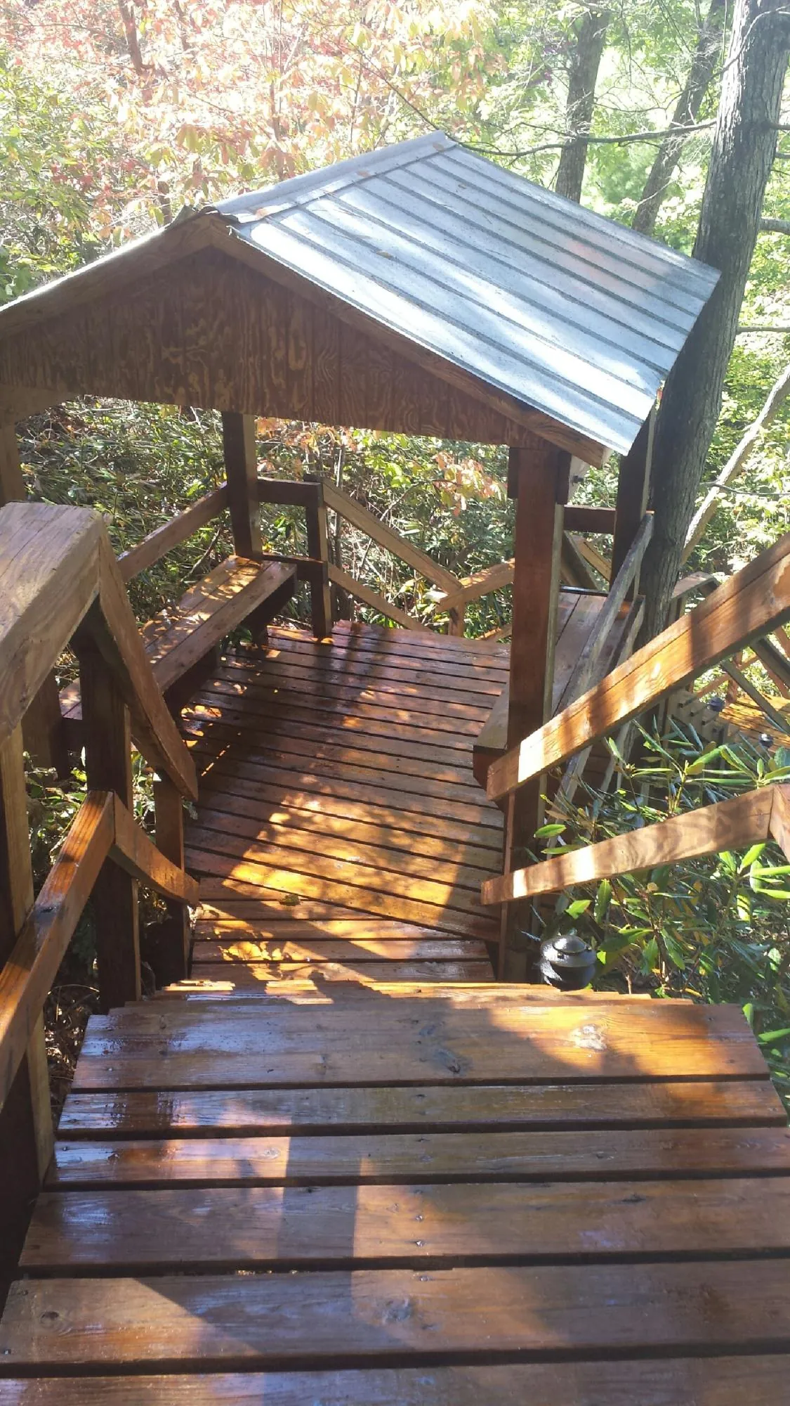 Freshly stained wood walkway and covered shelter with a metal roof in Waterville